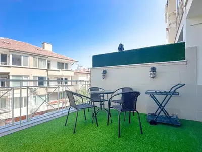 a patio with chairs and a table on a balcony at Stylish 1BD Apt in Lozenets with large balcony by Flat Manager in Sofia