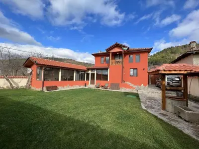 a house with a lawn in front of it at Villa Geshevi in Hisarya