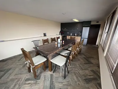 a dining room with a wooden table and chairs at Villa Geshevi in Hisarya