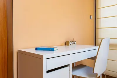 a white desk with a white chair in a room at Spacious 2BR Apt Kremena 10 minutes walk to Center in Plovdiv
