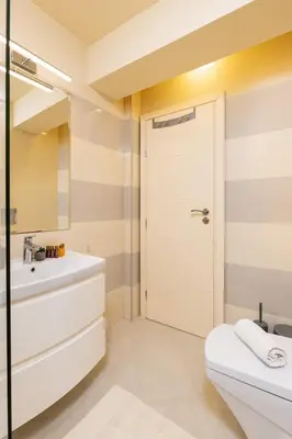 a bathroom with a white toilet and a sink at Spacious 2BR Apt Kremena 10 minutes walk to Center in Plovdiv