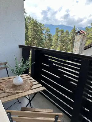 a balcony with a table and a vase on it at Приказна гледка B5 2 in Borovets