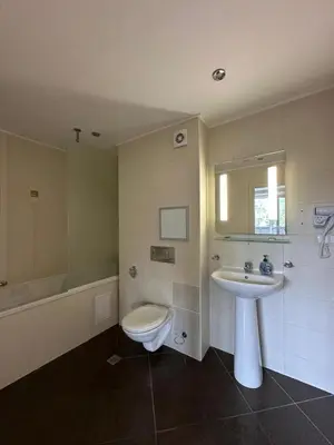 a bathroom with a sink and a toilet and a tub at Приказна гледка B5 2 in Borovets