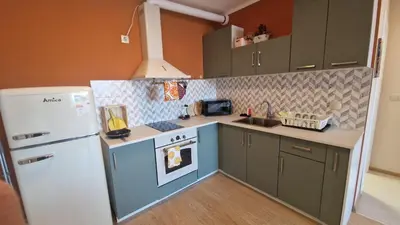 a kitchen with a blue stove and a white refrigerator at Boho Style in Samokov