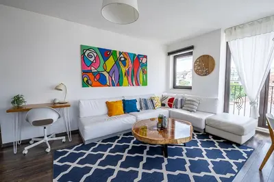 a living room with a white couch and a table at Mall of Sofia - UrbanLux Ampla 2BDR FREE Parking in Sofia