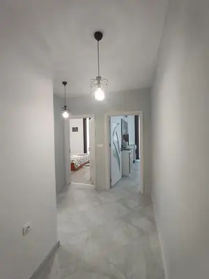 an empty room with white walls and a hallway at Apartment Active Sport in Pazardzhik