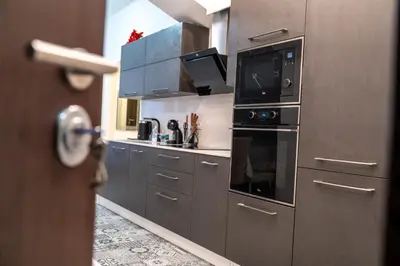 a kitchen with stainless steel cabinets and a microwave at Sofia Downtown Apartment in Sofia