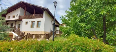 a house with a balcony on the side of it at 19 Rose in Bansko