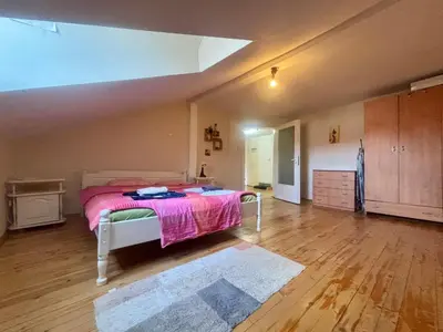 a bedroom with a bed with a pink blanket at Quiet and Lovely 2 BDRM loft in the Old Centre in Sofia