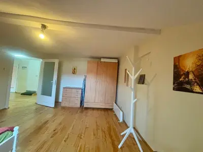 a living room with a wooden floor and a painting on the wall at Quiet and Lovely 2 BDRM loft in the Old Centre in Sofia