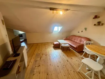 a living room with a couch and a table at Quiet and Lovely 2 BDRM loft in the Old Centre in Sofia