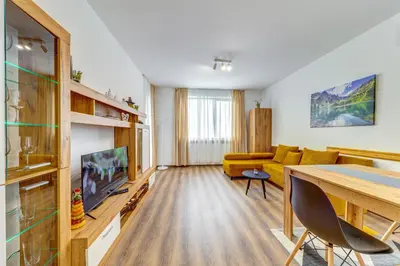 a living room with a yellow couch and a table at Villa Kometa - 1BD Apt with Balcony & Forest View by Flat Manager in Pamporovo