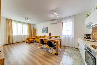 a kitchen and living room with a table and a couch at Villa Kometa - 1BD Apt with Balcony & Forest View by Flat Manager in Pamporovo