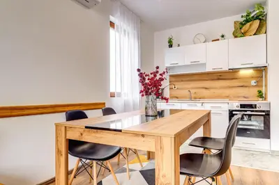 a kitchen with a wooden table and chairs at Villa Kometa - 1BD Apt with Balcony & Forest View by Flat Manager in Pamporovo