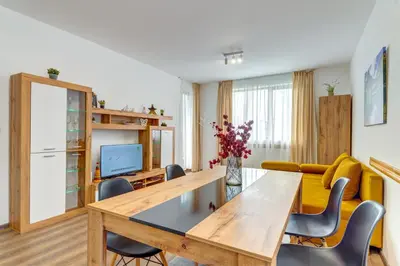 a living room with a table and a couch at Villa Kometa - 1BD Apt with Balcony & Forest View by Flat Manager in Pamporovo