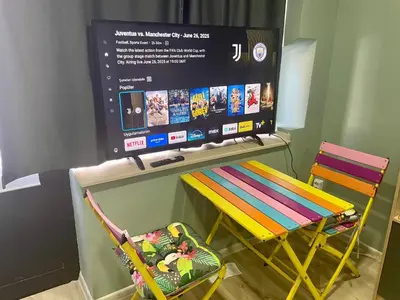 a tv sitting on top of a table with a chair at GuestHouse Karma369 in Plovdiv