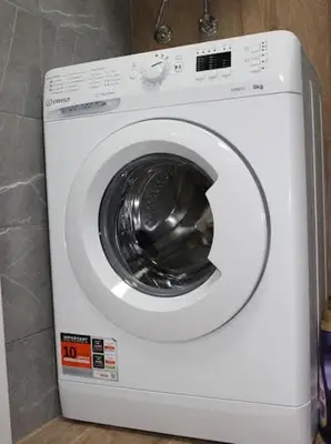 a white washing machine sitting in a room at Candy 26 Apartment in Velingrad