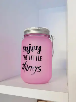 a pink jar with the words enjoy the little things at Candy 26 Apartment in Velingrad