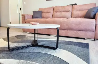 a coffee table in a living room with a couch at Candy 26 Apartment in Velingrad