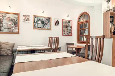 a living room with a table and chairs at Complex Popangelov in Borovets