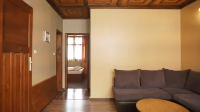 a living room with a couch and a table at Complex Popangelov in Borovets