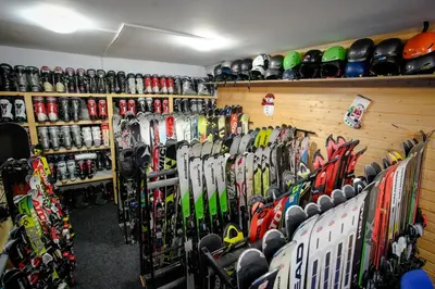 a room with a bunch of skis on the wall at Complex Popangelov in Borovets