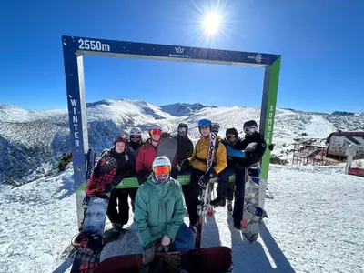 a group of people posing for a picture at the top of a mountain at Complex Popangelov in Borovets