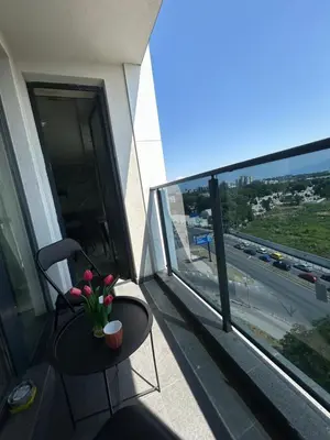 a table and a chair on a balcony with a window at Платинум 8 in Plovdiv