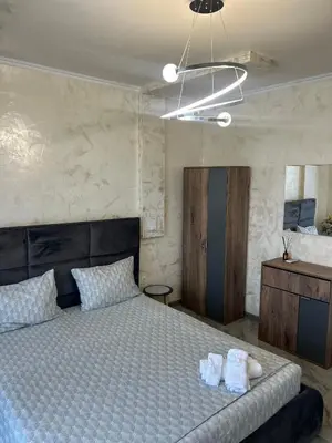a bedroom with a bed with two towels on it at Платинум 8 in Plovdiv