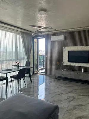 a living room with a television and a dining table at Платинум 8 in Plovdiv