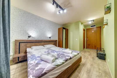 a bedroom with a large bed with white pillows at Two Cozy Mint Studios in Grand Resort Pamporovo by Flat Manager in Pamporovo