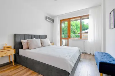 a bedroom with a large bed and a window at 2 Apartments, 2 Parking - Sleeps 8 - Quiet Central in Sofia
