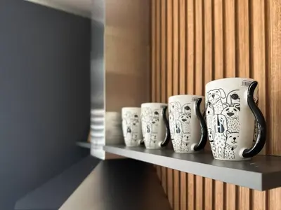 four coffee mugs are sitting on a shelf at 2 Apartments, 2 Parking - Sleeps 8 - Quiet Central in Sofia