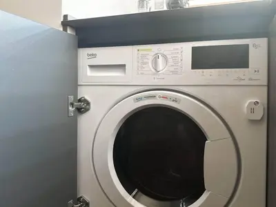 a washing machine in a room with a wall at 2 Apartments, 2 Parking - Sleeps 8 - Quiet Central in Sofia