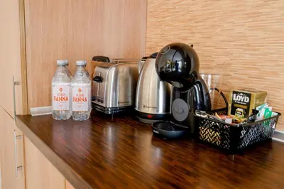 a kitchen counter with bottles of water and a mixer at My orchids apartment in the heart of Sofia in Sofia