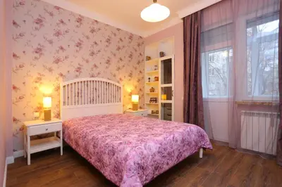 a bedroom with a bed and two tables and a window at Apartment in Sofia Centre by Flat Manager in Sofia