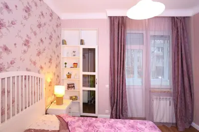 a bedroom with a crib and pink wallpaper at Apartment in Sofia Centre by Flat Manager in Sofia