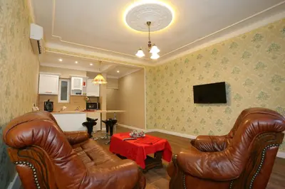 a living room with two leather chairs and a table at Apartment in Sofia Centre by Flat Manager in Sofia