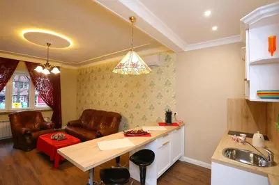 a kitchen with a table and chairs and a couch at Apartment in Sofia Centre by Flat Manager in Sofia