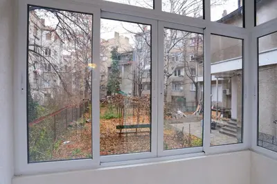 a room with windows looking out at a yard at Apartment in Sofia Centre by Flat Manager in Sofia