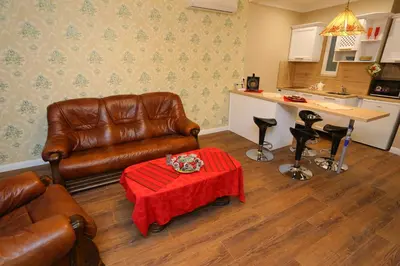 a living room with a leather couch and a table at Apartment in Sofia Centre by Flat Manager in Sofia
