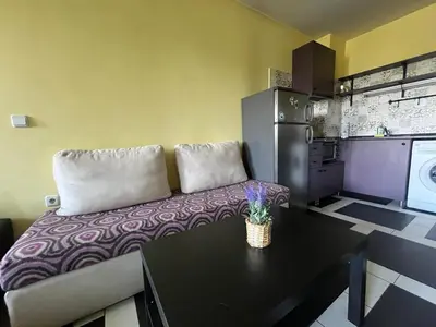 a kitchen with a couch and a table in a room at Einstein apartment in Sofia