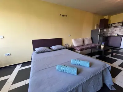 a bedroom with a large bed and a couch at Einstein apartment in Sofia