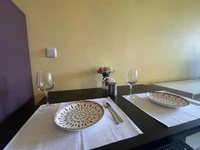 a table with two plates and two wine glasses at Einstein apartment in Sofia