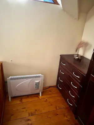 a room with a heater in the corner of a room at Chalet Hamars - Highland Haven in Razlog