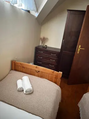 a bedroom with a bed with two towels on it at Chalet Hamars - Highland Haven in Razlog