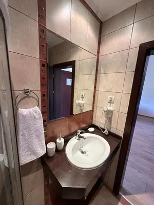 a bathroom with a sink and a mirror at Top floor and mountain views in Razlog
