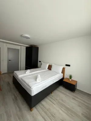 a bedroom with a large bed with white sheets at Gorna Banya luxury apartments in Sofia