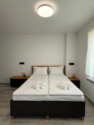 a bedroom with a bed with two towels on it at Gorna Banya luxury apartments in Sofia
