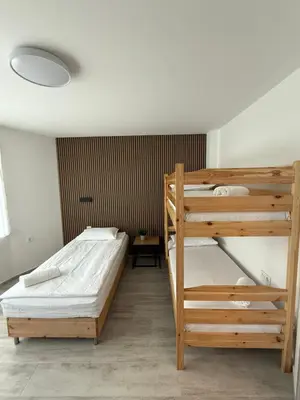 a bedroom with two bunk beds and a table at Gorna Banya luxury apartments in Sofia